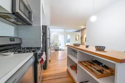 a kitchen with a stove and a counter top at XL Prime Tribeca Furnished Loft, June To Aug 90 Days Stay Required in New York