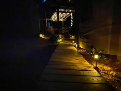 a walkway at night with lights on it at Secluded in the Woods Cedar Hot Tub Pet Friendly in Mehoopany