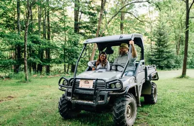 a man and a woman sitting in a jeep at Secluded in the Woods Cedar Hot Tub Pet Friendly in Mehoopany