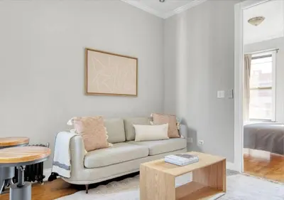 a living room with a couch and a table at Midtown West Furnished Apartment 3BR in New York