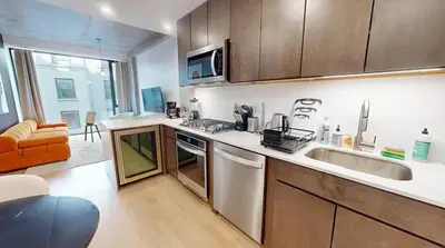 a kitchen with a sink and a stove top oven at Sleek Two Bedroom in Manhattan in New York