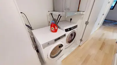 a laundry room with a washer and a washing machine at Sleek Two Bedroom in Manhattan in New York