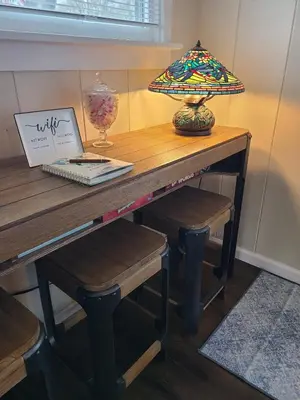 a table with a lamp on top of it at Riverfront Cottage in Owego in Owego