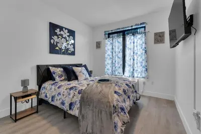 a bedroom with a bed and a window at Blue Bliss Indoor Pool, FREE Parking, Near NYC in Elizabeth