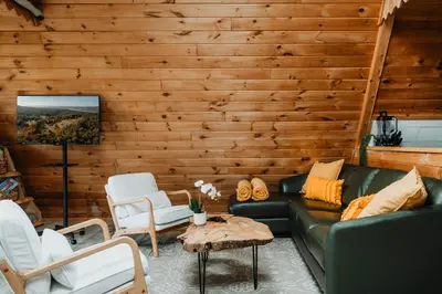a living room with a green couch and chairs at Rustic Escape UTV, Tub, Trails & Fire Pit 25 acre in Roscoe