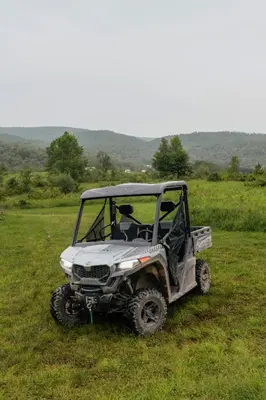 a white four wheeler parked in a field at Rustic Escape UTV, Tub, Trails & Fire Pit 25 acre in Roscoe
