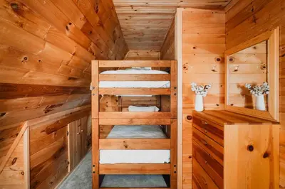 a wooden cabin with bunk beds in it at Rustic Escape UTV, Tub, Trails & Fire Pit 25 acre in Roscoe
