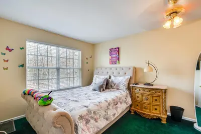 a bedroom with a bed and a window at Theater and Game Room at Trenton Area Home in Edgewood Park