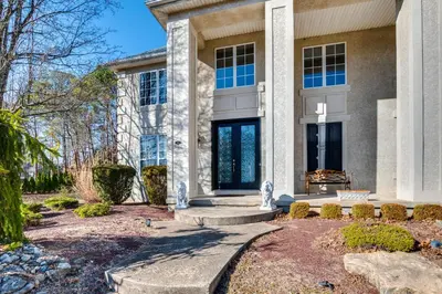 a home with a large stone building at Theater and Game Room at Trenton Area Home in Edgewood Park