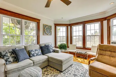 a living room with a couch and chairs and windows at Game Room, Yard and Fire Pit Spacious Catskills Gem in Sparrow Bush