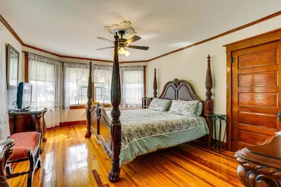 a bedroom with a bed and a ceiling fan at Game Room, Yard and Fire Pit Spacious Catskills Gem in Sparrow Bush