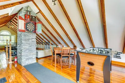 a kitchen with a table and a clock in a room at Game Room, Yard and Fire Pit Spacious Catskills Gem in Sparrow Bush