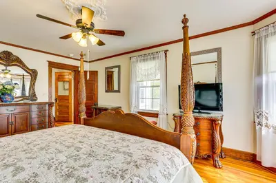 a bedroom with a bed and a ceiling fan at Game Room, Yard and Fire Pit Spacious Catskills Gem in Sparrow Bush