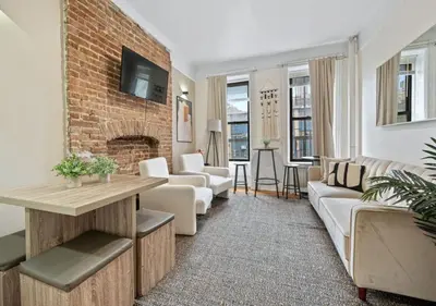 a living room with a couch and a fireplace at Upper West Side Furnished 1 Bedroom Apartment, June to Aug 90 days stay required in New York