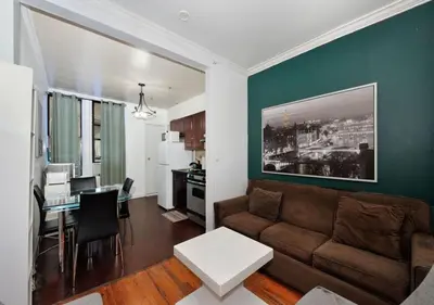 a living room with a couch and a table at Furnished 2 Bedroom Apartment Midtown West NYC, June To Aug 90 Days Stay Required in New York