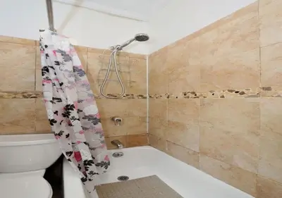 a bathroom with a toilet and a shower curtain at Furnished 2 Bedroom Apartment Midtown West NYC, June To Aug 90 Days Stay Required in New York