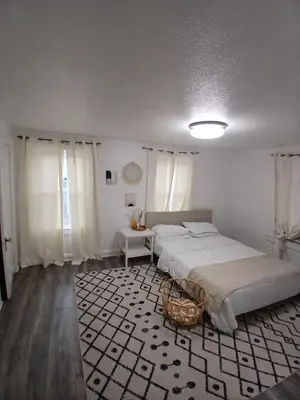 a bedroom with two beds and a basket on a rug at Monthly Stays - 2BR Apt in Bloomfield - 8 Min Walk from NJ Transit in Bloomfield