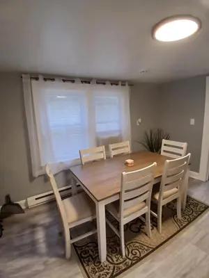a dining room with a wooden table and chairs at Monthly Stays - 2BR Apt in Bloomfield - 8 Min Walk from NJ Transit in Bloomfield