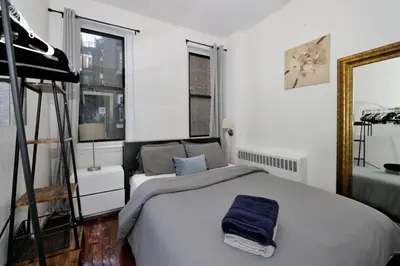 a bedroom with a bed with a blue towel on it at Furnished Apartment Room Rental In NYC, June To Aug 90 Days Stay Required in New York