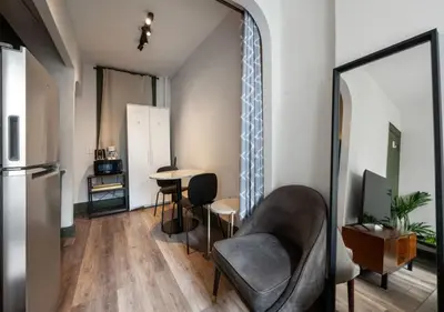 a living room with a chair and a table at Prime Murray Hill 2 BR Gem, June To Aug 90 Days Stay Required in New York
