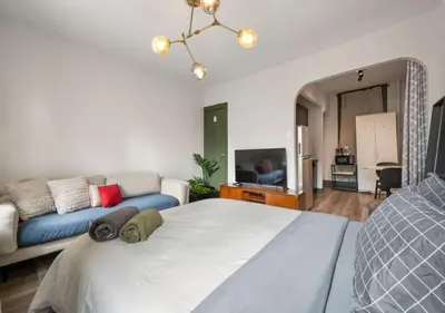 a bedroom with a large bed and a couch at Prime Murray Hill 2 BR Gem, June To Aug 90 Days Stay Required in New York