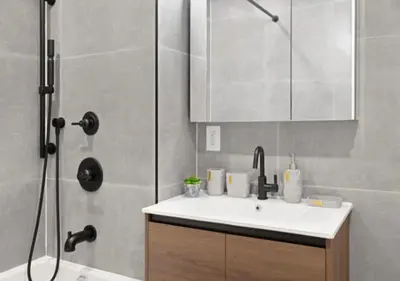 a bathroom with a sink and a shower at Murray Hill 1 Bed Furnished Apt in New York