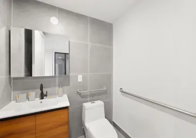 a bathroom with a white toilet and a sink at Murray Hill 1 Bed Furnished Apt in New York