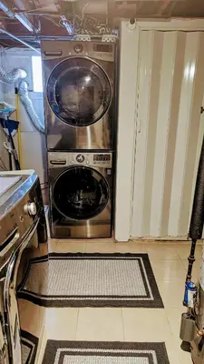 a washer and dryer sitting in a kitchen at Charming Private 1BR Apartment with Easy NYC Access in Maplewood