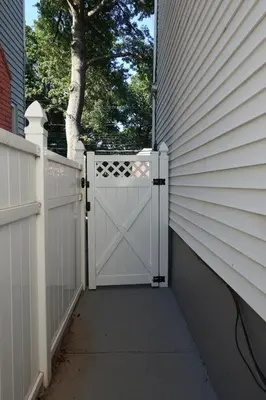 an open garage door on a house with a fence at Charming Private 1BR Apartment with Easy NYC Access in Maplewood
