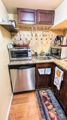 a kitchen with a sink and a microwave at Charming Private 1BR Apartment with Easy NYC Access in Maplewood