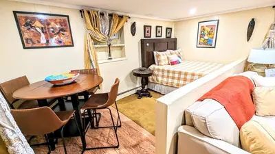 a small room with a table and a bed at Charming Private 1BR Apartment with Easy NYC Access in Maplewood