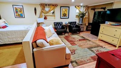 a bedroom with a bed and a living room at Charming Private 1BR Apartment with Easy NYC Access in Maplewood