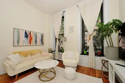 a living room with a couch and a table and chairs at Prime Location Murray Hill! Grand Central Station!, June To Aug 90 Days Stay Required in New York