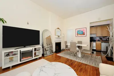 a living room with a large flat screen tv at Prime Location Murray Hill! Grand Central Station!, June To Aug 90 Days Stay Required in New York