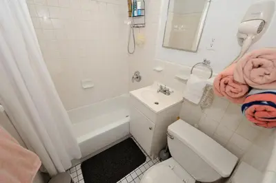 a bathroom with a toilet and a tub and a sink at Prime Location Murray Hill! Grand Central Station!, June To Aug 90 Days Stay Required in New York