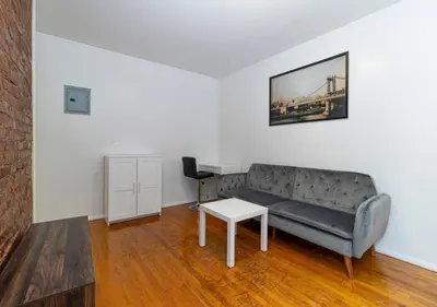 a living room with a couch and a table at Murray Hill and Kips Bay! Amazing 1BR for 2! in New York