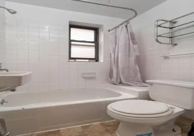 a bathroom with a toilet and a tub and a sink at Murray Hill and Kips Bay! Amazing 1BR for 2! in New York