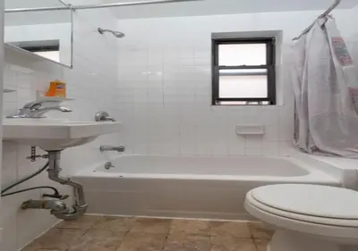a bathroom with a tub and a toilet and a sink at Murray Hill and Kips Bay! Amazing 1BR for 2! in New York