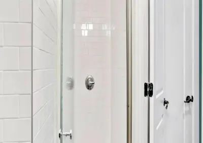 a shower with a glass door in a bathroom at Amazing Studio in Kips Bay! in New York