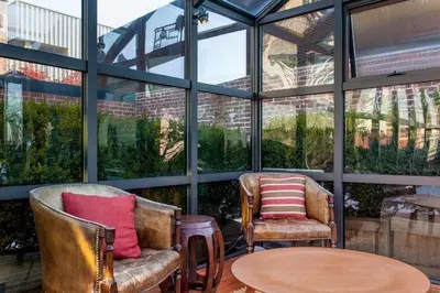 two chairs and a table in a room with windows at Roedonis SoHo in New York