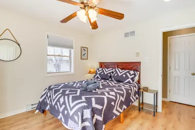 a bedroom with a bed with a ceiling fan at Walk to Lake Harmony Family Retreat with Decks! in Albrightsville