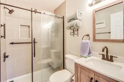 a bathroom with a shower and a toilet and a sink at Walk to Lake Harmony Family Retreat with Decks! in Albrightsville