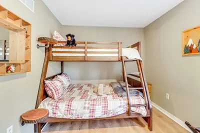a bunk bed in a room with a bunk bed in a house at Walk to Lake Harmony Family Retreat with Decks! in Albrightsville