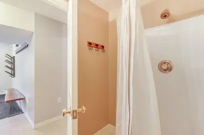 a bathroom with a shower with a white shower curtain at Walk to Lake Harmony Family Retreat with Decks! in Albrightsville