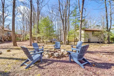a group of chairs sitting around a fire pit at Walk to Lake Harmony Family Retreat with Decks! in Albrightsville