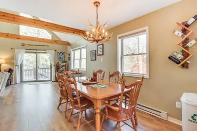 a dining room with a wooden table and chairs at Walk to Lake Harmony Family Retreat with Decks! in Albrightsville