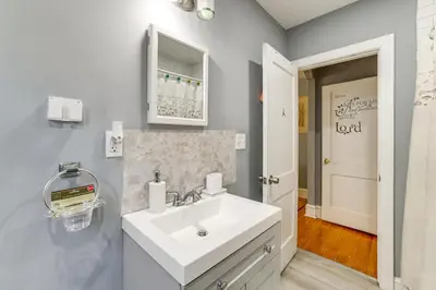 a bathroom with a white sink and a mirror at 3 Mi to Penn Pet-Friendly Townhome in Yeadon! in Yeadon