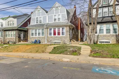 a large house on the corner of a street at 3 Mi to Penn Pet-Friendly Townhome in Yeadon! in Yeadon