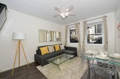 a living room with a couch and a glass table at Amazing 4 BR 1 BTH Laundry Dishwasher, June To Aug 90 Days Stay Required in New York