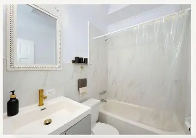 a bathroom with a sink and a toilet and a mirror at Four Bedroom Prime Furnished Rental, June To Aug 90 Days Stay Required in New York